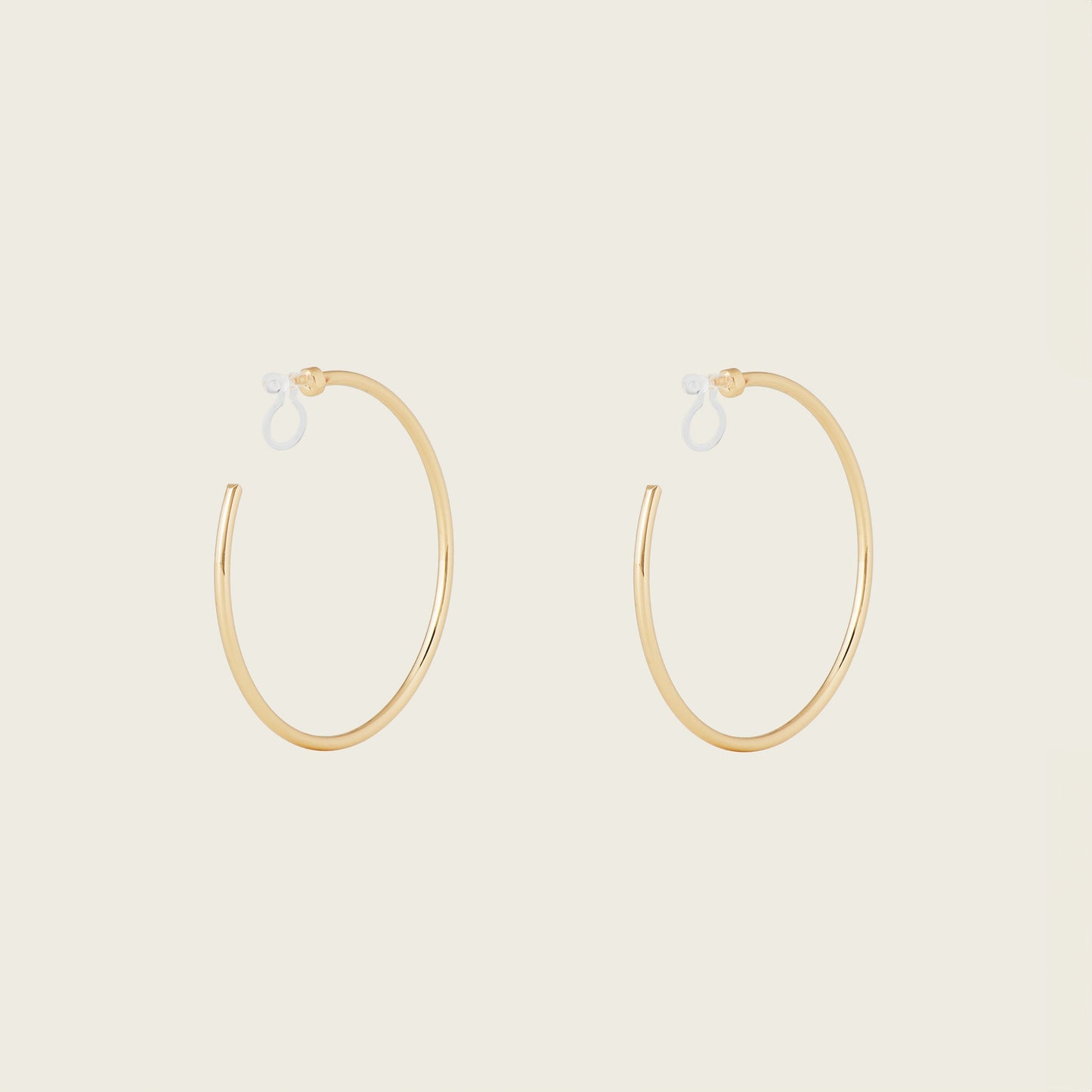 https://cdn.shopify.com/s/files/1/0569/3286/0096/files/LargeThinHoopsinGold_1_edca2f99-88f6-4f6d-b51e-7f9682c50904.jpg?v=1754934974