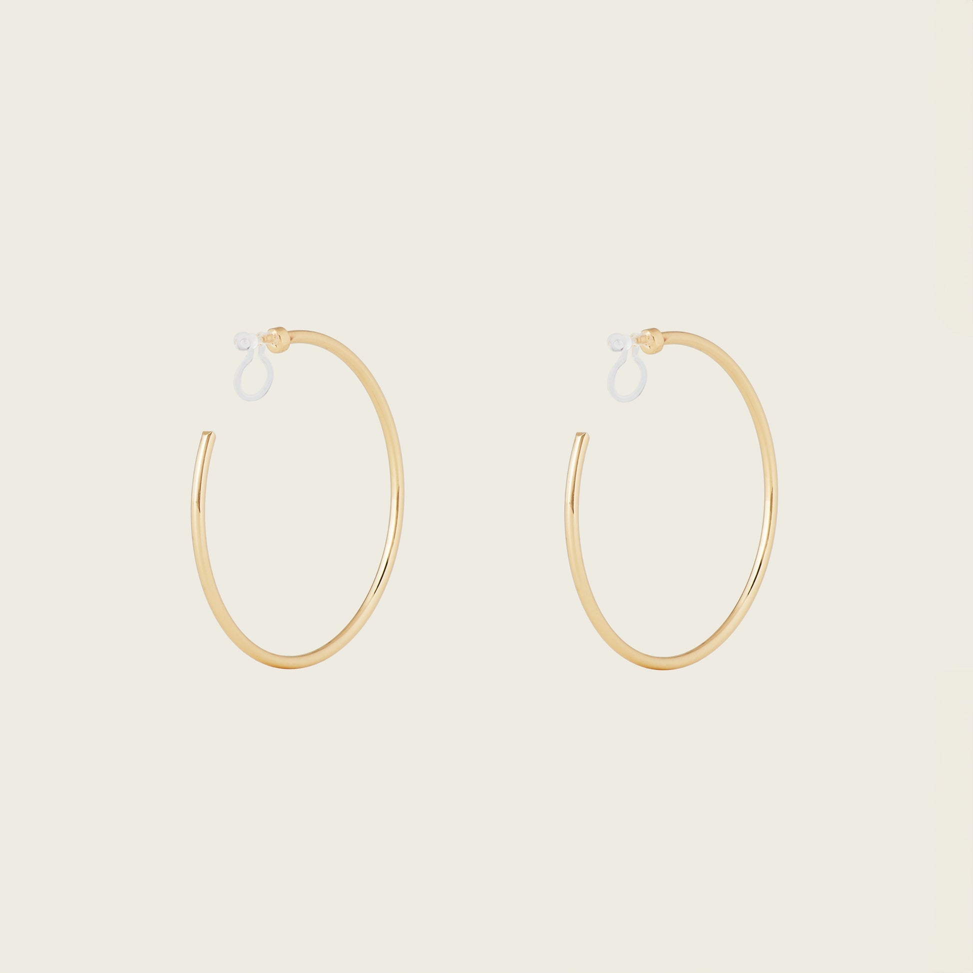 https://cdn.shopify.com/s/files/1/0569/3286/0096/files/LargeThinHoopsinGold_1_edca2f99-88f6-4f6d-b51e-7f9682c50904.jpg?v=1754934974